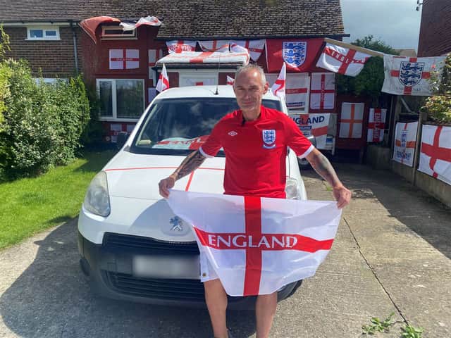 Martin Baker pictured outside his St George's flag covered home. 